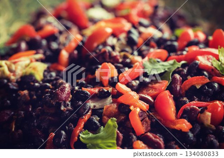 Showing flat design close-up of bean salad featuring beans, peppers, tomatoes, blurred background Showing flat design close-up of bean salad featuring beans, peppers, tomatoes, blurred background 134080833