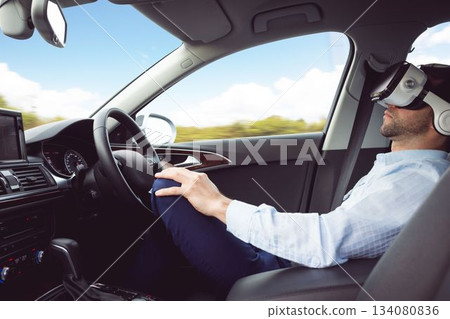man behind the wheel wearing a virtual reality helmet 134080836