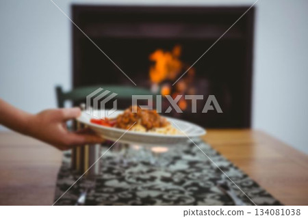 Cropped image of hand holding food in plate 134081038