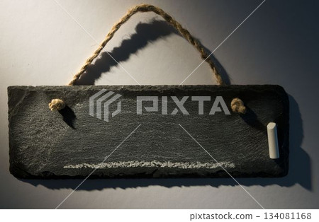 Hanging chalkboard on dark background 134081168