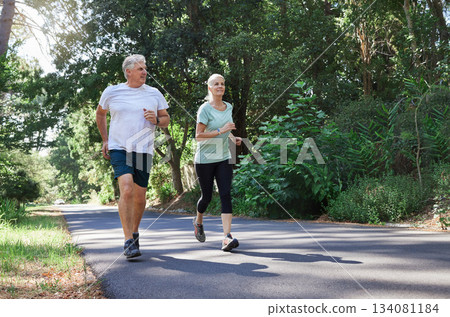 Fitness, senior and a couple running in a park for cardio, retirement exercise and movement. Happy, morning and an elderly man and woman jogging for health, training and active together in nature Fitness, senior and a couple running in a park for cardio, retirement exercise and movement. Happy, morning and an elderly man and woman jogging for health, training and active together in nature 134081184