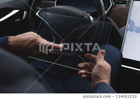 Man using glass digital tablet in van 134081230