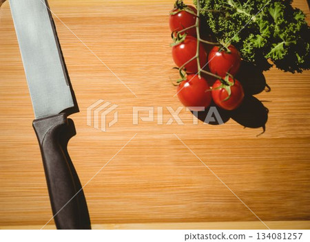Cherry tomatoes and parsley on chopping board Cherry tomatoes and parsley on chopping board 134081257