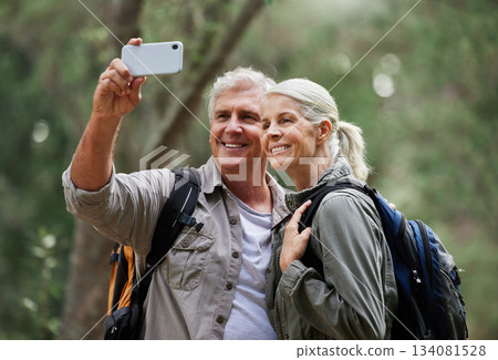 Selfie, hiking and happy mature couple of friends in forest adventure, journey and outdoor health with happy blog update. Nature, travel and trekking people in woods together and profile picture post 134081528