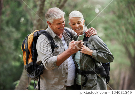 Phone, video call and elderly couple hiking in a forest, happy and smile while bonding on adventure. Active seniors, online and maps for man and woman backpacking in nature while checking location Phone, video call and elderly couple hiking in a forest, happy and smile while bonding on adventure. Active seniors, online and maps for man and woman backpacking in nature while checking location 134081549