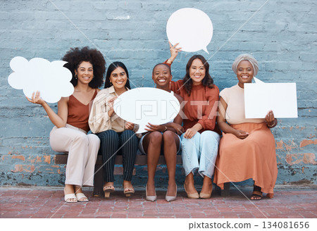 Portrait, speech bubble and diversity with business women outdoor, holding blank space for text. Collaboration, social media and communication with a happy female employee team sitting on a bench Portrait, speech bubble and diversity with business women outdoor, holding blank space for text. Collaboration, social media and communication with a happy female employee team sitting on a bench 134081656
