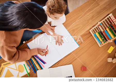 Learning, top view and mother with kid drawing in book in family home for studying, homework or homeschool help. Creative development, art and boy with mom teaching him art for education child growth Learning, top view and mother with kid drawing in book in family home for studying, homework or homeschool help. Creative development, art and boy with mom teaching him art for education child growth 134081682