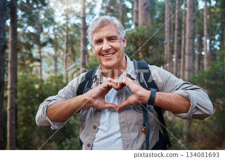 Portrait, heart and senior man in forest hiking, fitness and health support, self care hands and cardiovascular workout. Nature, travel or trekking of happy person in woods with love sign or emoji 134081693