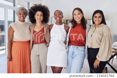 Portrait of a diverse group of smiling ethnic business women standing together in the office. Ambitious happy confident professional team of colleagues embracing while feeling supported and empowered 134081768