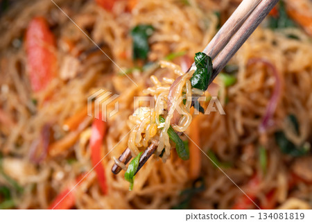 Japchae, Korean stir fried glass noodles with vegetables, pork, soy sauce and sesame seed 134081819