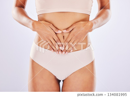 Hands, stomach and belly of a woman natural model with smooth skin isolated in a studio white background. Weight loss, diet and female touch abdomen for healthcare, fitness and nutrition Hands, stomach and belly of a woman natural model with smooth skin isolated in a studio white background. Weight loss, diet and female touch abdomen for healthcare, fitness and nutrition 134081995