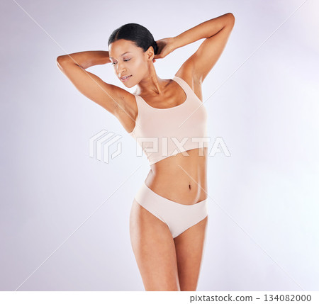 Beauty, underwear and body with a model woman in studio on a gray background to promote skincare. Natural, wellness and health with an attractive young female posing in lingerie for hair removal Beauty, underwear and body with a model woman in studio on a gray background to promote skincare. Natural, wellness and health with an attractive young female posing in lingerie for hair removal 134082000