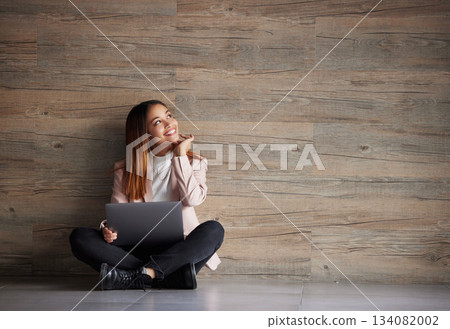 Happy woman, thinking and laptop with space for idea for advertising or mockup. Smile of female on wooden background for internet connection for computer search, promotion or student scholarship 134082002