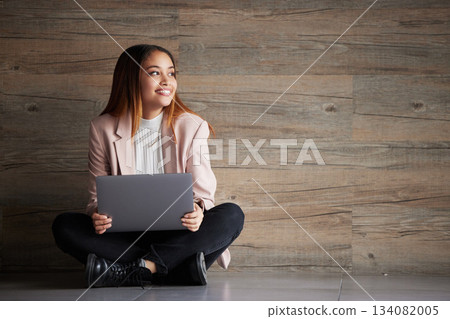 Woman, thinking and laptop with space for idea for advertising or product placement mockup. Smile of female on wooden background for internet connection for search, inspiration or student scholarship 134082005
