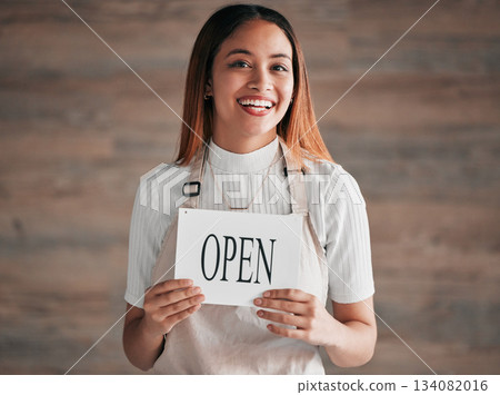 Coffee shop, portrait and woman holding an open sign in studio on a blurred background for hospitality. Cafe, startup and small business with a female entrepreneur indoor to display advertising Coffee shop, portrait and woman holding an open sign in studio on a blurred background for hospitality. Cafe, startup and small business with a female entrepreneur indoor to display advertising 134082016