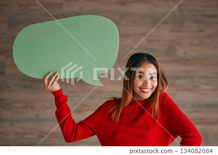 Business woman, speech bubble and portrait by wall with happiness, opinion and social media in workplace. Businesswoman, paper and poster for news, announcement and happy with sign, vote and voice Business woman, speech bubble and portrait by wall with happiness, opinion and social media in workplace. Businesswoman, paper and poster for news, announcement and happy with sign, vote and voice 134082084