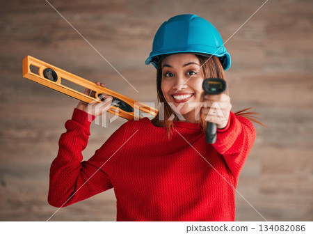 Construction, business woman and portrait of a property management worker with engineer tools. Safety helmet, smile and engineering stud detector for a home renovation project with a female employee 134082086