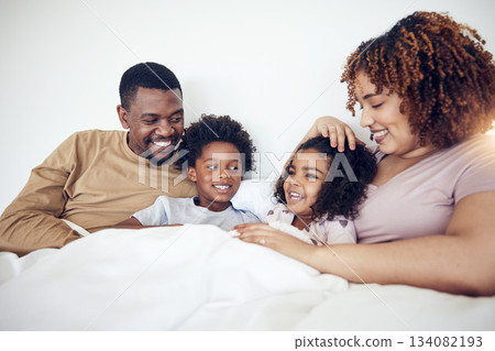 Family, father and mother with children on bed relaxing together for fun morning or holiday break at home. Happy dad, mom and kids relax and lying in bedroom enjoying comfort and bonding time Family, father and mother with children on bed relaxing together for fun morning or holiday break at home. Happy dad, mom and kids relax and lying in bedroom enjoying comfort and bonding time 134082193