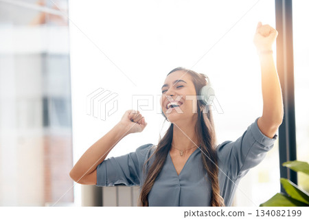Business woman, headphones and dance in office for happiness, motivation and fun celebration of smile. Happy female employee, dancing and laughing to music for success, inspiration and excited energy 134082199