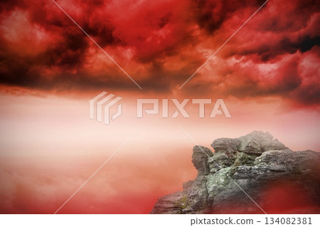 Large rock overlooking red sky 134082381