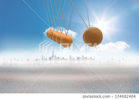 Newtons cradle above city in desert 134082404