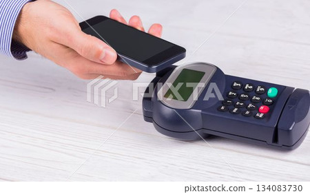 Man using smartphone to express pay 134083730