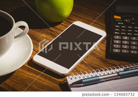 Flat design showing smartphone on desk, coffee cup and green apple, calculator, notebook with pen Flat design showing smartphone on desk, coffee cup and green apple, calculator, notebook with pen 134083732