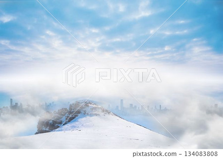 Snow-covered ridge is rising above low clouds in flat design, revealing distant city skyline 134083808