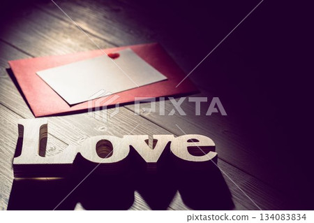 Love text with envelope on wooden table Love text with envelope on wooden table 134083834