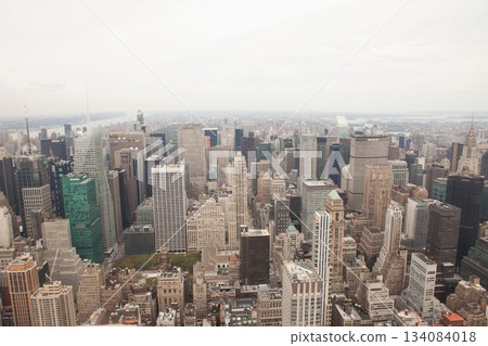 Panorama is showing dense skyline in flat design with towers and antennas, river under cloudy sky Panorama is showing dense skyline in flat design with towers and antennas, river under cloudy sky 134084018