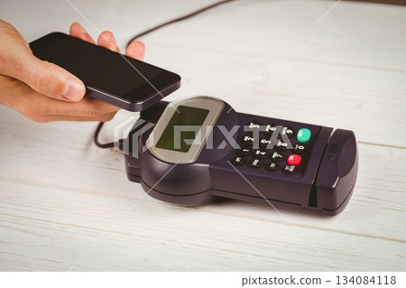 Man using smartphone to express pay Man using smartphone to express pay 134084118
