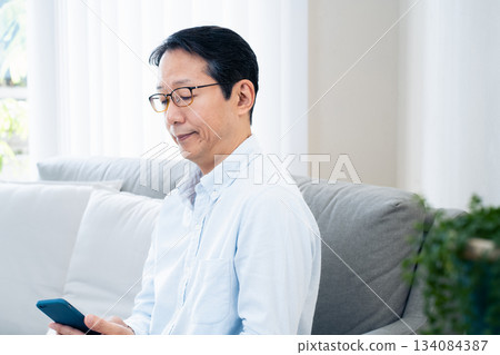 Mature man using a smartphone 134084387