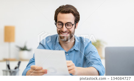Successful Business. Happy Entrepreneur Looking Through Papers And Documents Reading Positive Report And Correspondence Sitting At Laptop In Modern Office. Happy Businessman At Work. Selective Focus Successful Business. Happy Entrepreneur Looking Through Papers And Documents Reading Positive Report And Correspondence Sitting At Laptop In Modern Office. Happy Businessman At Work. Selective Focus 134084727