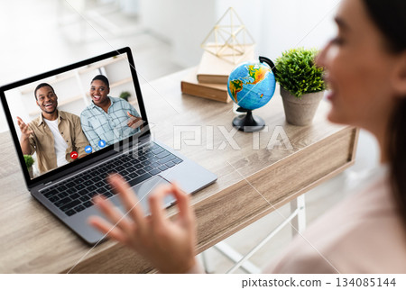 Female Tour Agent And Black Family Communicating Via Video Call On Laptop Approving Deal Gestuting Thumbs Up And OK During Online Consultation Indoor. Modern Distance Communication. Selective Focus 134085144