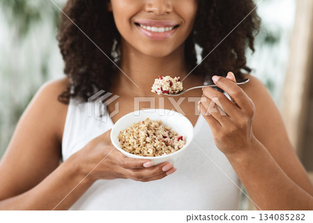 Healthy Nutrition. Unrecognizable Black Woman Enjoying Oatmeals With Fruits, Holding Plate With Diet Breakfast Food, Cropped Image 134085282
