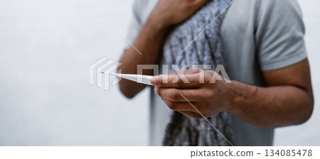 Sick African Man Having Fever Holding Thermometer Suffering From Coronavirus Disease Standing On Gray Studio Background, Touching Aching Throat Having Difficulty Breathing. Cropped, Selective Focus 134085478