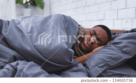 Sick Black Man Sleeping Lying In Bed Having Cold And Flu Symptoms At Home. Ill African American Guy Resting In Bedroom Suffering From Coronavirus Disease. Covid-19 Concept. Selective Focus 134085736