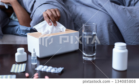 Ill African American Man Sneezing Having Sinusitis Lying On Sofa At Home. Sick Black Guy Blowing Runny Nose In Paper Handkerchief Suffering From Cold And Rhinitis Symptoms. Selective Focus Ill African American Man Sneezing Having Sinusitis Lying On Sofa At Home. Sick Black Guy Blowing Runny Nose In Paper Handkerchief Suffering From Cold And Rhinitis Symptoms. Selective Focus 134085808