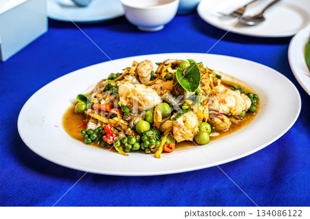 Spicy stir fried fish with herbs 134086122