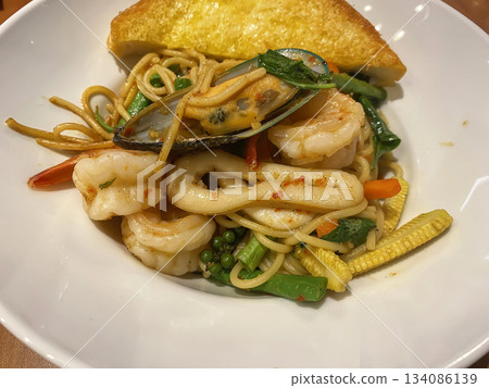 Spicy seafood spaghetti stir-fry 134086139