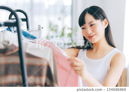 A woman choosing clothes A woman choosing clothes 134086969