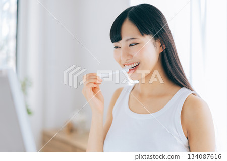 A young woman brushing teeth A young woman brushing teeth 134087616