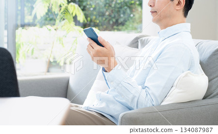 Mature man using a smartphone 134087987