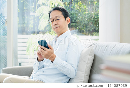 Mature man using a smartphone 134087989