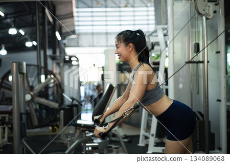 A woman exercise chest workout on cable chest press machine, Fitness and workout concept A woman exercise chest workout on cable chest press machine, Fitness and workout concept 134089068