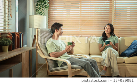 Young couple relax in living room with hot coffee 134089091