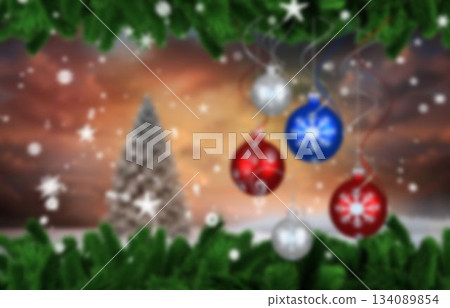 Winter design is showing hanging Christmas baubles with evergreen branches and snowflakes 134089854