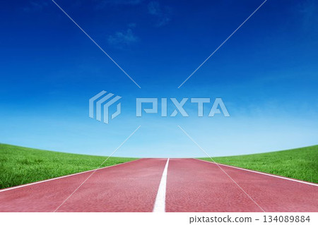 Red track with white center line is being shown in flat design through grassy hills 134089884
