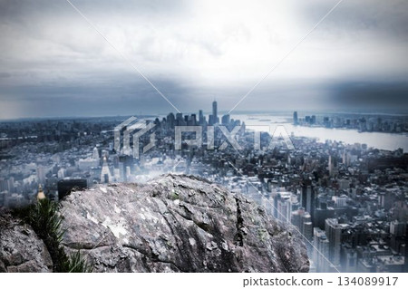 Large rock overlooking huge city Large rock overlooking huge city 134089917