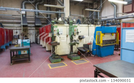 Green drill presses are standing in flat design workshop, showcasing blue press and red partitions 134090031